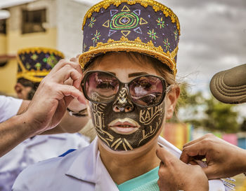 Portrait of woman holding sunglasses