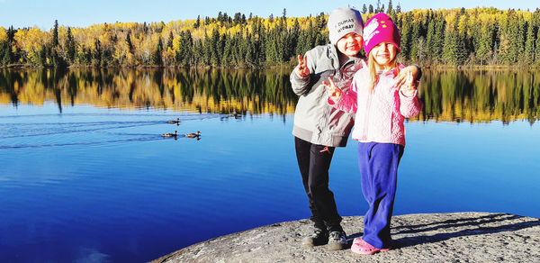 Siblings portrait by the lake