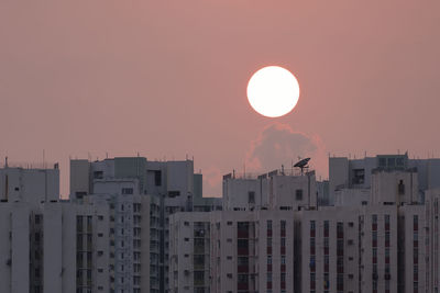 Low angle view of buildings against sky during sunset