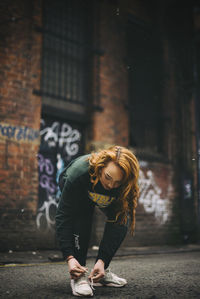 Full length of woman standing on footpath