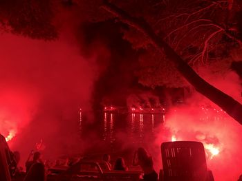 People by lake night