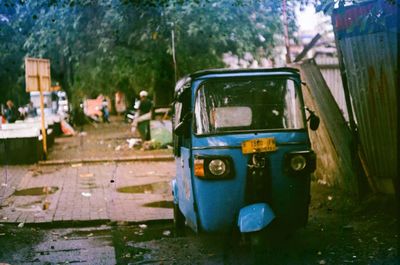 Abandoned car on road in city