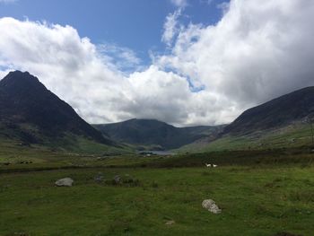 Scenic view of mountains against cloudy sky