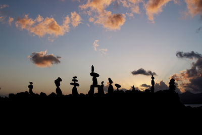 Silhouette people against sky during sunset