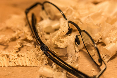 Close-up of eyeglasses and wax on table