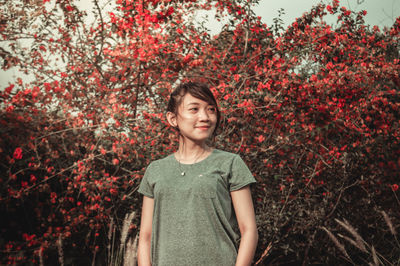 Portrait of a beautiful young woman standing in autumn