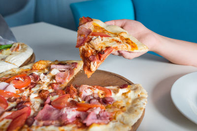 Italian pizza in a children's hand close-up