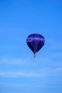 Low angle view of hot air balloon against blue sky