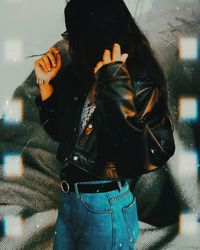 Midsection of person holding umbrella while standing outdoors