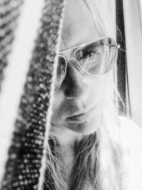 Close-up portrait of young woman wearing sunglasses