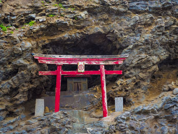 Low angle view of red text on rock formation