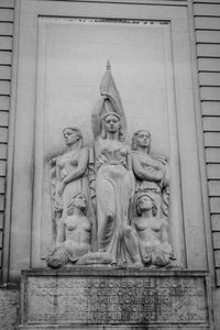 Low angle view of statue against old building