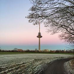 Communications tower against sky during sunset