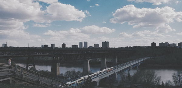 High angle view of bridge over river amidst buildings in city