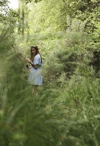 Rear view of woman standing on field