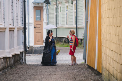 Side view of women standing in a building