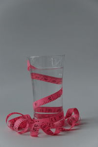 Close-up of red glass against white background