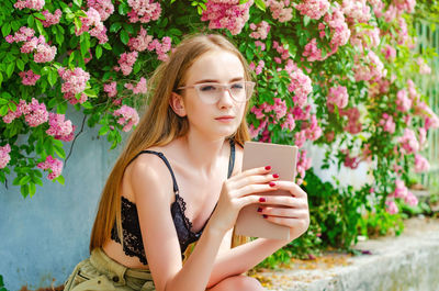 Portrait of girl holding mobile phone