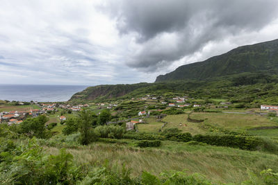 Scenic view of sea and mountains against sky