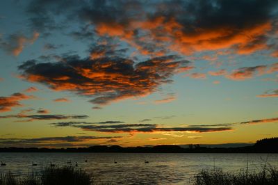 Scenic view of lake at sunset