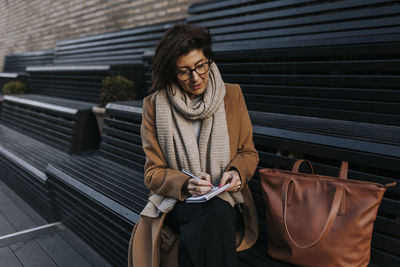 Businesswoman sitting on bench