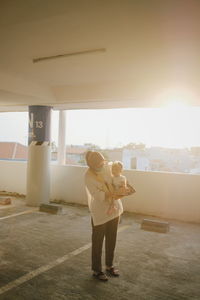 Rear view of woman standing against the sky