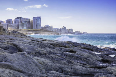 Scenic view of sea and buildings against sky