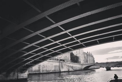 Low angle view of bridge over river in city