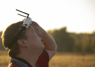 Side view of man looking up against sky