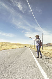 Man standing on road against sky