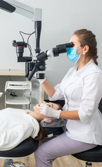 Female doctor examining patient at clinic