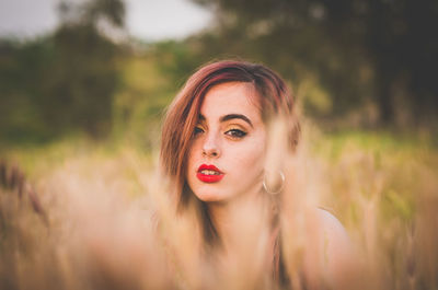 Portrait of young woman on field