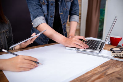 Midsection of man using mobile phone