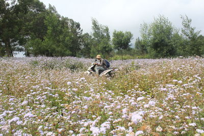 A person who is walking among beautiful flowers