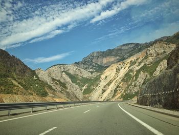 Road amidst mountains against sky