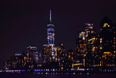 Panoramic view of illuminated buildings against sky at night