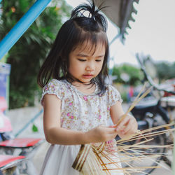 Cute girl holding sticks