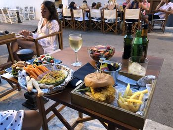 Midsection of woman sitting at restaurant table