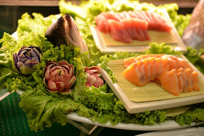 Close-up of sushi with vegetables served in plate