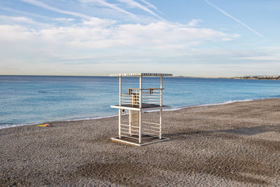 Lifeguard hut on beach against sky