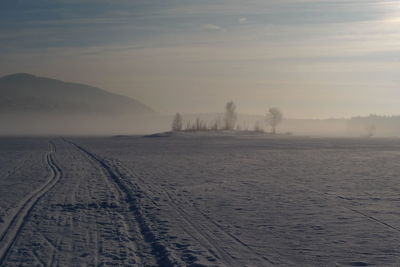 Scenic view of landscape against sky during winter