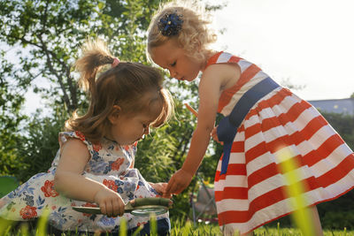 Rear view of mother and daughter outdoors