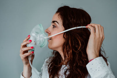 Portrait of a beautiful young woman drinking glass