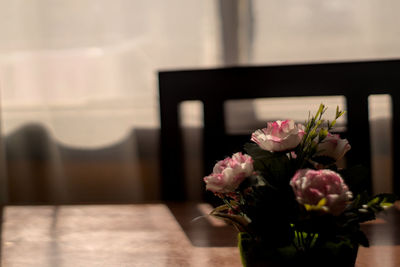 Close-up of pink flower vase on table at home