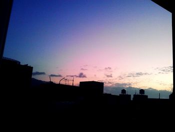 Low angle view of buildings against sky at sunset