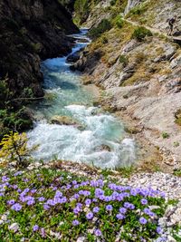 Scenic view of water flowing through rocks in river