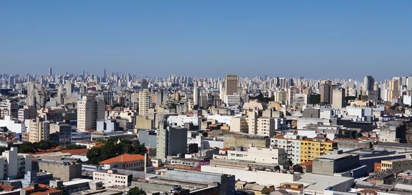 High angle view of buildings in city against clear sky