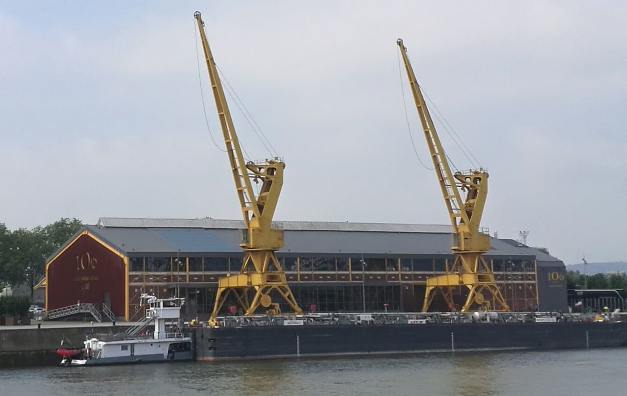 water, sky, transportation, crane - construction machinery, architecture, waterfront, machinery, industry, built structure, river, nature, day, mode of transportation, construction industry, no people, outdoors, nautical vessel, building exterior, business, construction equipment