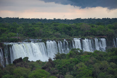 Scenic view of waterfall against sky