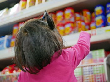 Rear view of woman with hat in store